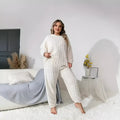 Women's creamy white polyester two-piece tracksuit set with crew neck top and matching trousers