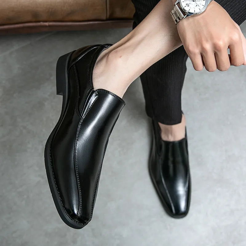 Men's black pointed patent leather shoes with leather lining and flat heel on a neutral background