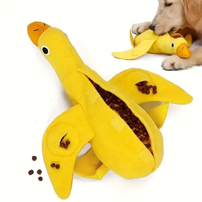 Yellow plush duck dog toy with squeaker and treat dispensing holes for training and chewing.