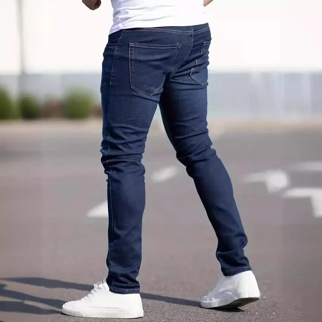 Dark blue men's slim fit casual jeans with a tight leg style and mid waist design.