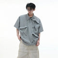 Men's geometric pattern polo shirt with deconstructed collar in grey, shown in a loose fit.