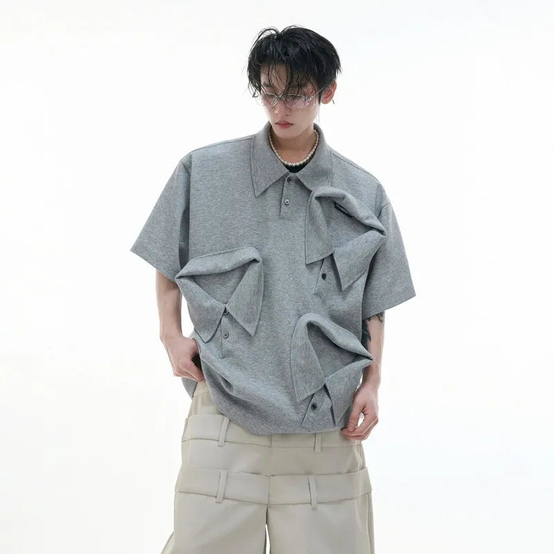 Men's geometric pattern polo shirt with deconstructed collar in grey, shown in a loose fit.
