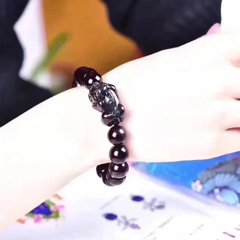 Natural ice colour eye obsidian crystal bracelet on wrist showing bead size.