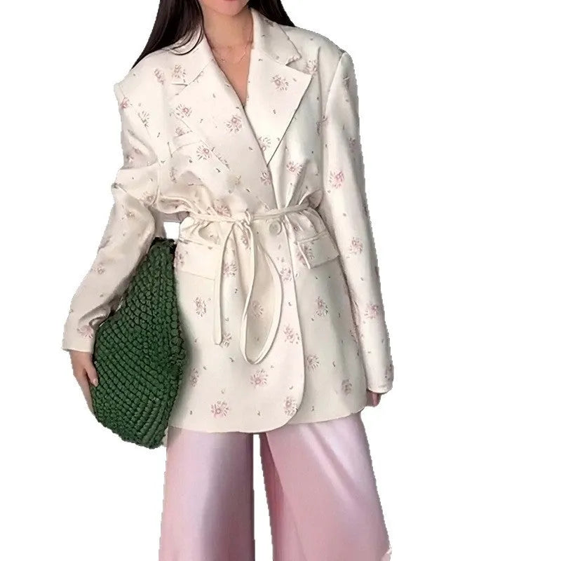 Women's apricot suit jacket with lace-up detail on the collar and a cinched waist.