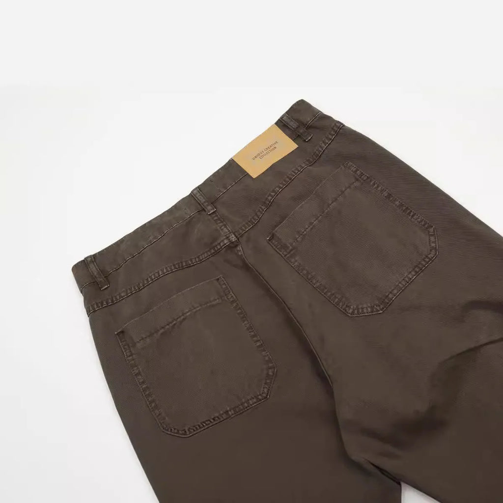 Men's loose straight-leg cotton trousers in brown colour with a high waist and wide leg opening.