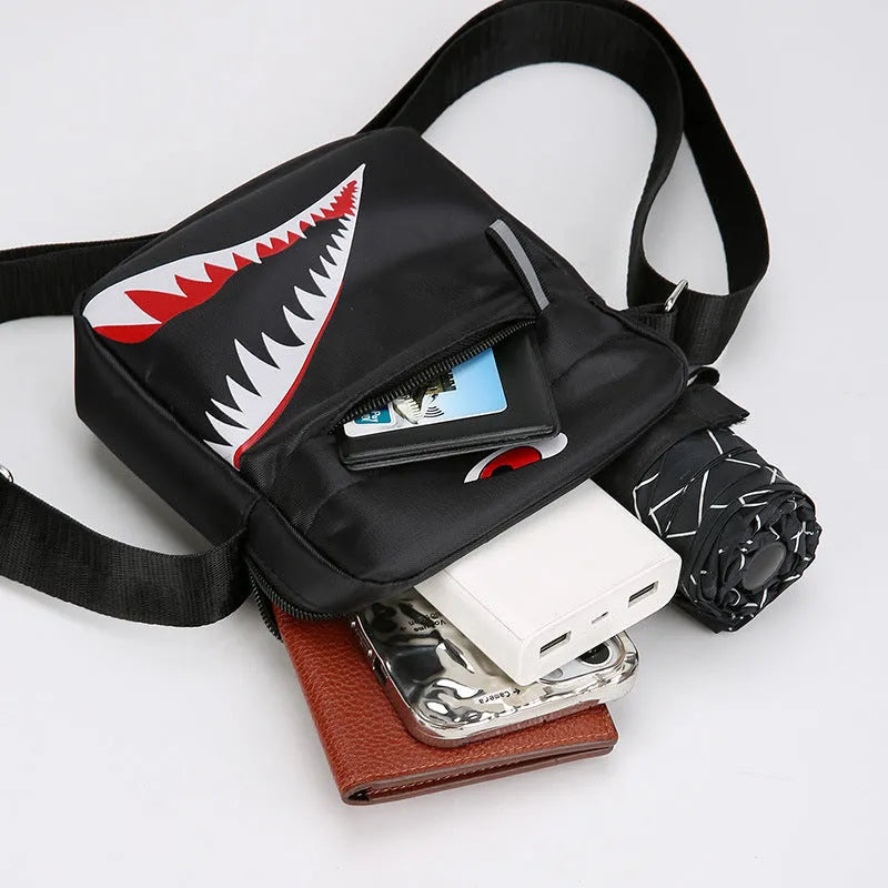 Men's small casual crossbody bag in Oxford cloth, shown in black with adjustable strap and animal print lining visible.