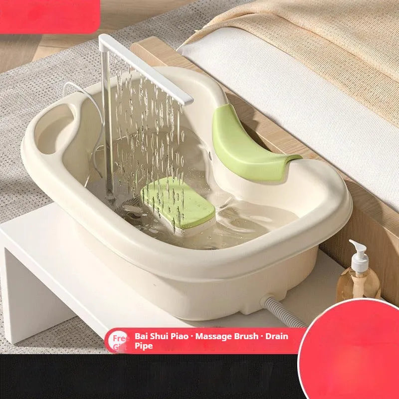 Pregnant woman lying in bed using shampoo pot with head pad and water pump, light pink colour