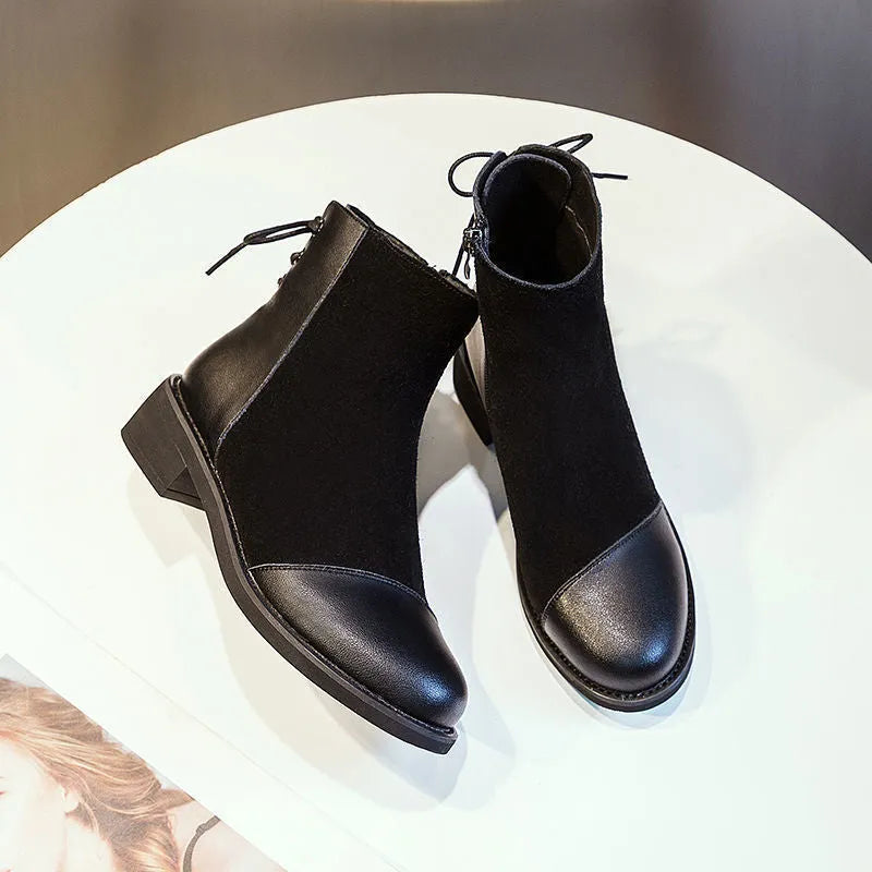 Women's black Martin boots with side zipper, round toe, and decorative bow detail