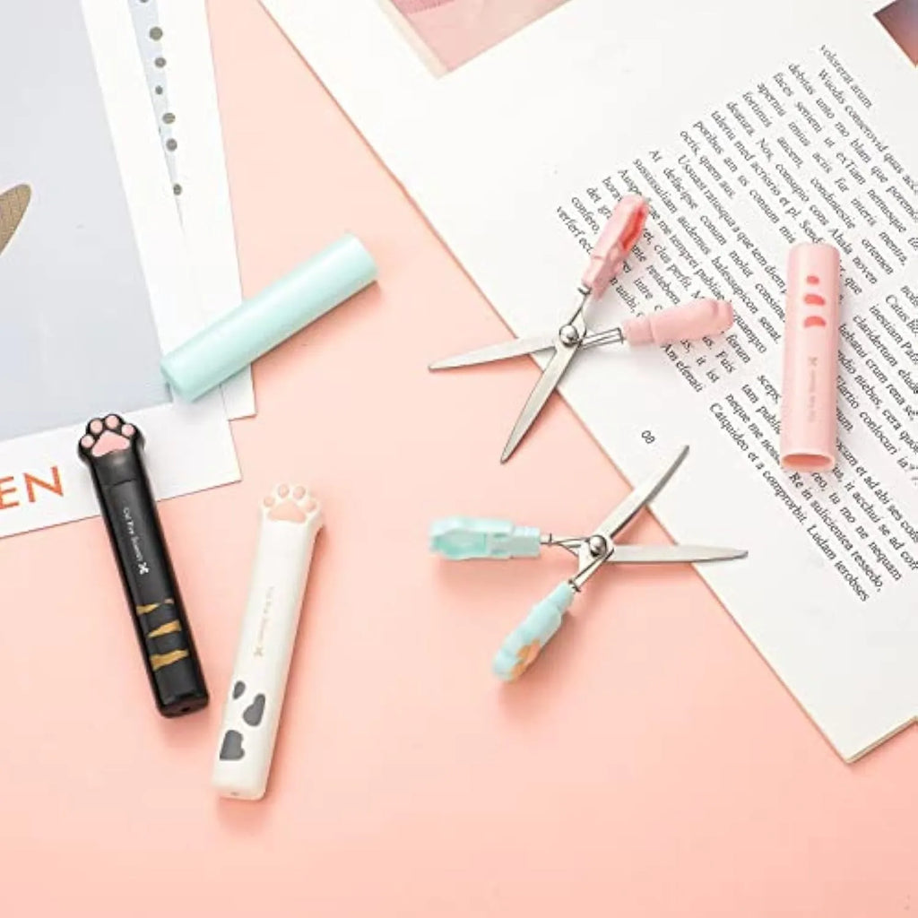 Cat paw mini folding craft scissors in four colours: black, blue, pink, and white, showing closed and open positions.