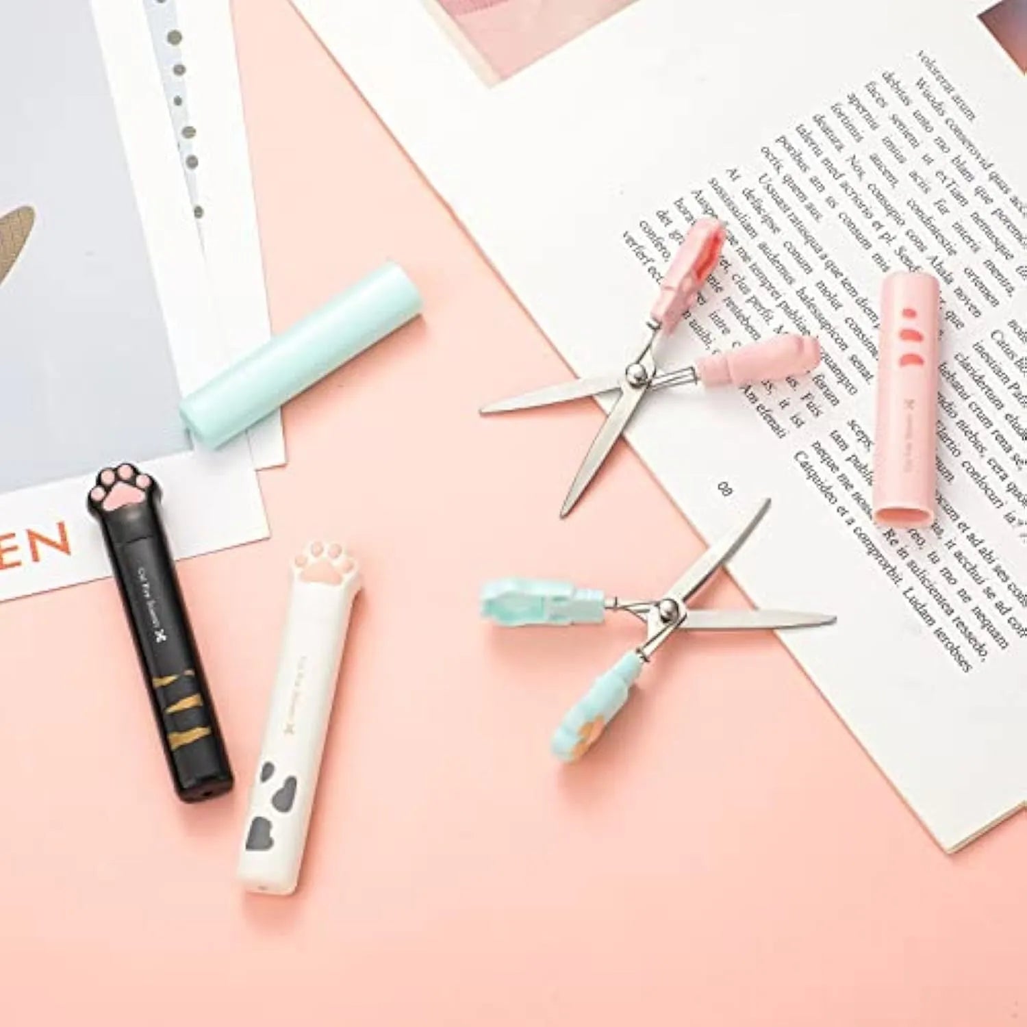 Cat paw mini folding craft scissors in four colours: black, blue, pink, and white, showing closed and open positions.