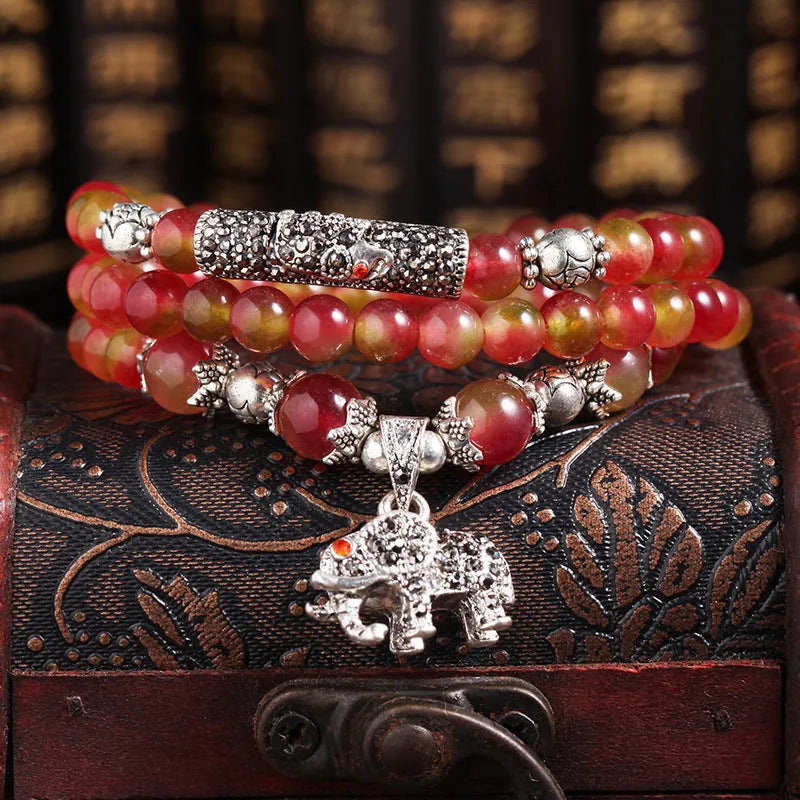Natural watermelon crystal Chinese knot bracelet with elephant style beads.