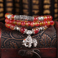 Natural watermelon crystal Chinese knot bracelet with elephant style beads.