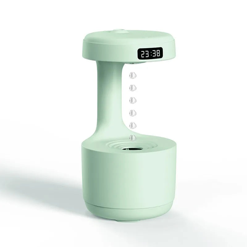 White anti-gravity air humidifier with ultrasonic mist levitating water drops on a desk