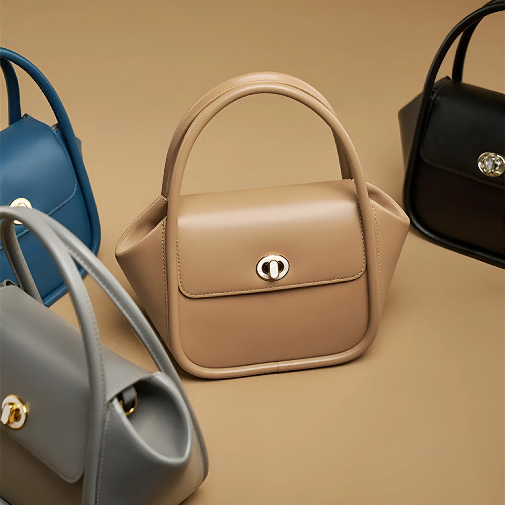 Women's wing-shaped cow leather tote handbag with a buckle closure in a choice of four colours.