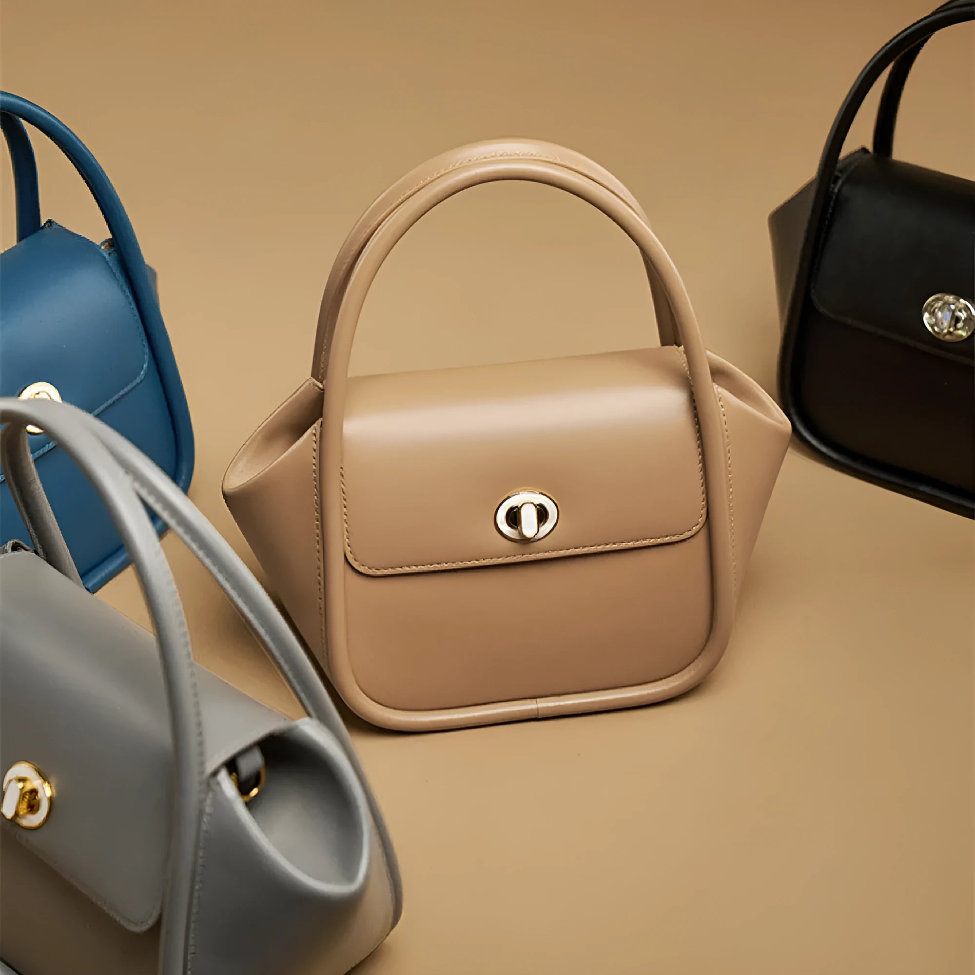 Women's wing-shaped cow leather tote handbag with a buckle closure in a choice of four colours.