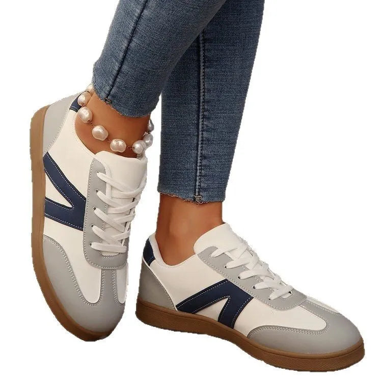 Women's blue flat German training hiking shoes with rubber sole and artificial PU upper, low-top lace-up style on neutral background
