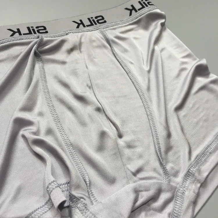 Men's silk shorts in loose fit design showing navy blue, silver grey, and skin colour options