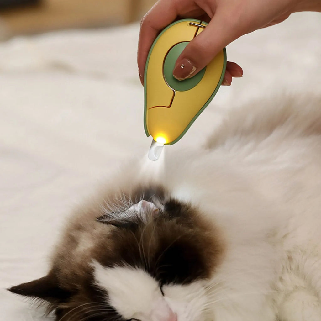 Green professional pet nail clipper with LED light on, showing safety guard and ergonomic handle.