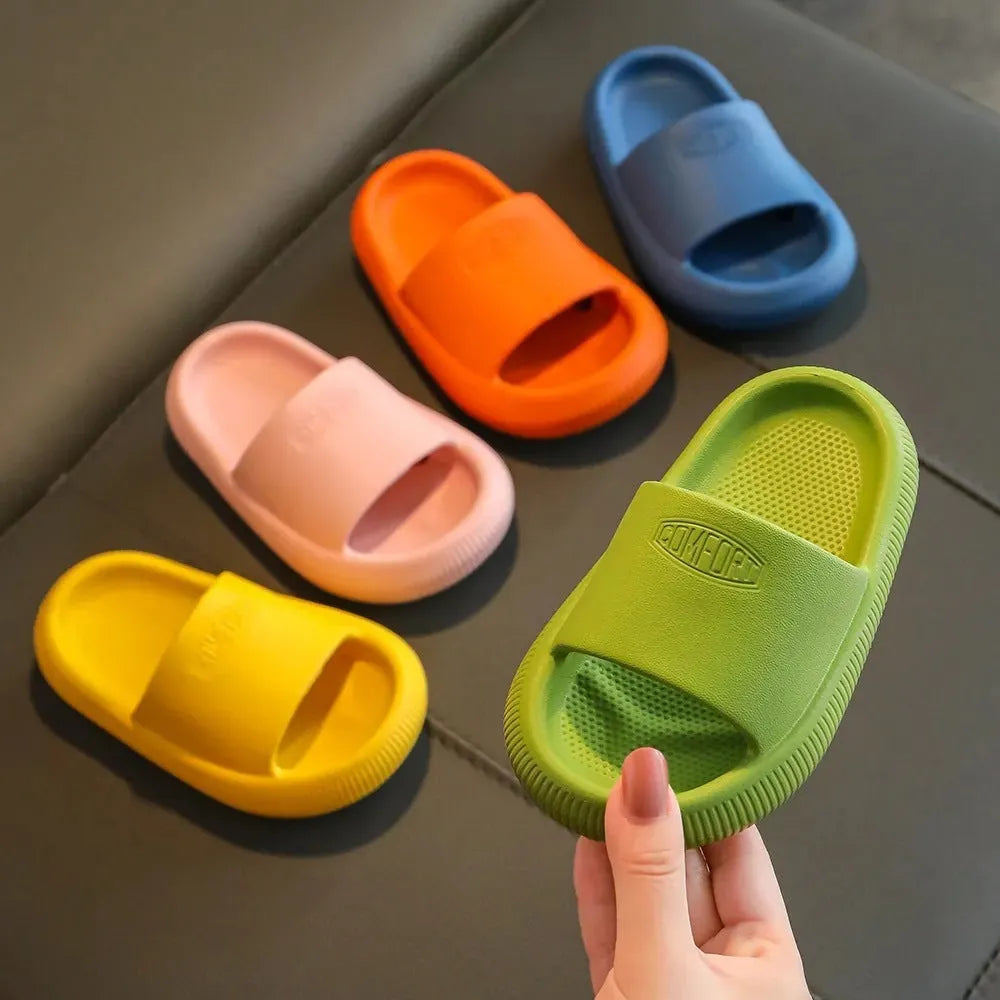 Children's bright coloured EVA slippers with textured non-slip soles on a white background.