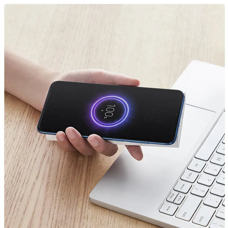 White and black 10000mAh power bank showing USB-C port and wireless charging surface