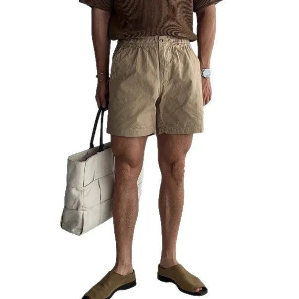 A pair of loose-fit cotton sports shorts in black, shown on a white background.