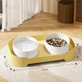 Green ceramic elevated cat bowl set with two bowls on a tilted stand for food and water.