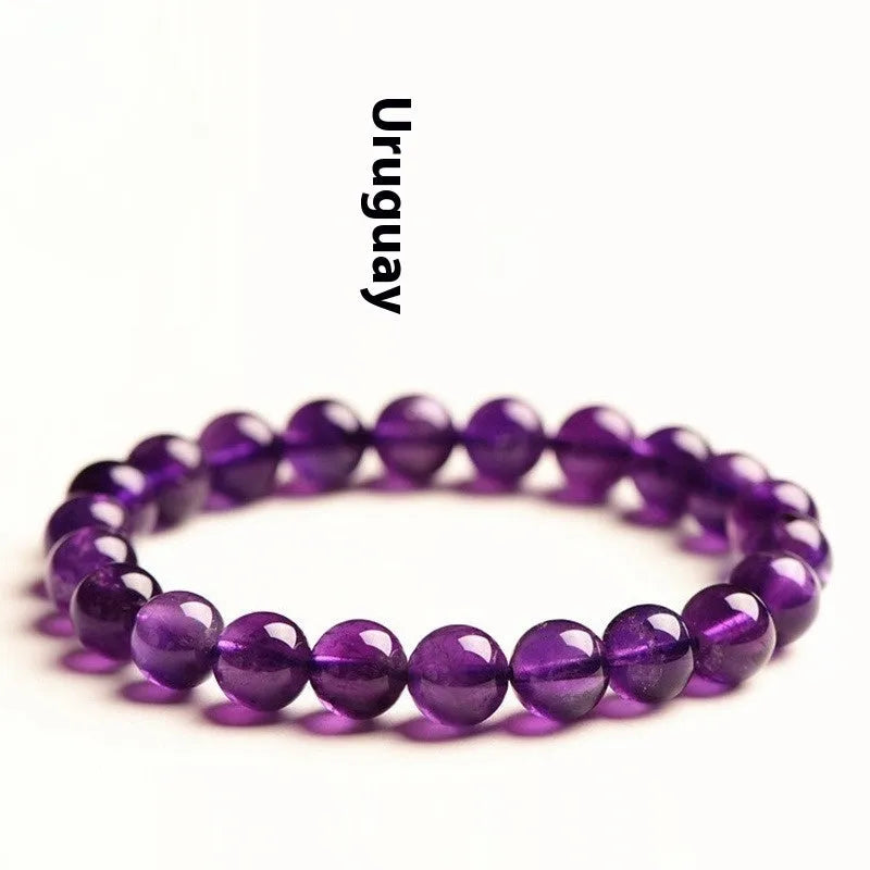 Natural Uruguayan amethyst crystal bracelet with round polished beads on a black stretch cord.