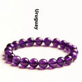 Natural Uruguayan amethyst crystal bracelet with round polished beads on a black stretch cord.