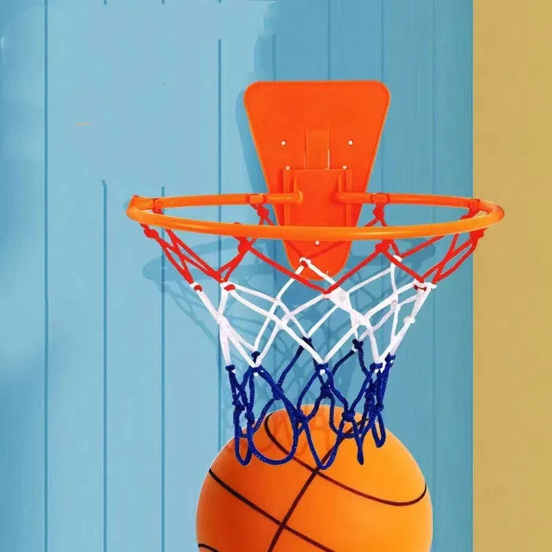 Assorted bright silent foam basketballs in different sizes next to a basketball hoop frame.