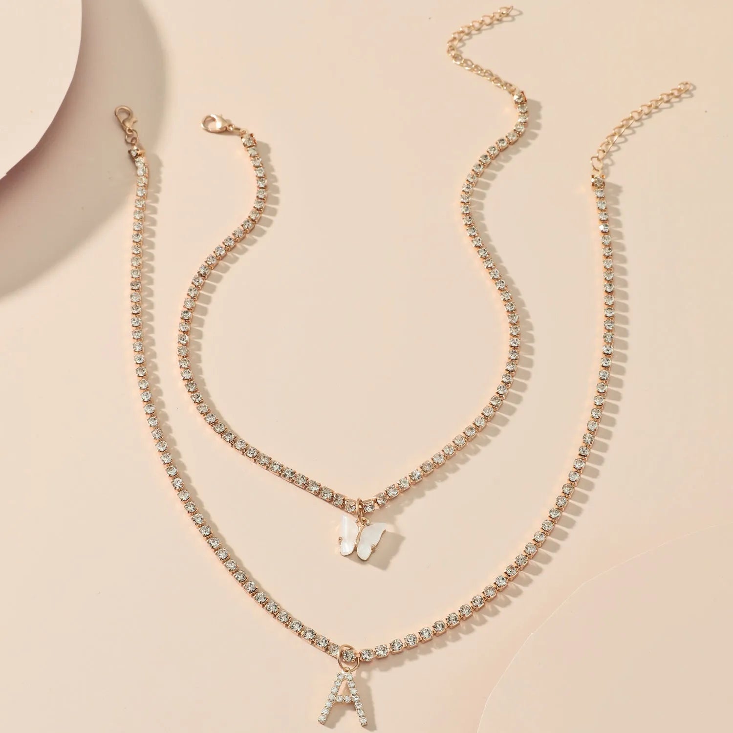 Personalised diamond letter necklace with rhinestone pendant on claw chain in gold finish