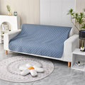 Reversible dog blanket couch cover in black with double-layer design, laid flat on sofa