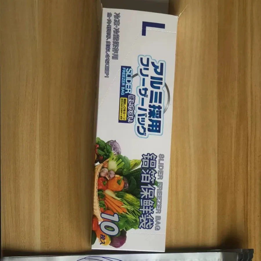 Set of resealable aluminium foil fresh-keeping bags in small, medium, and large sizes on a kitchen counter.