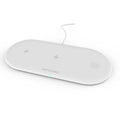 Black and white 3-in-1 wireless charging station for Apple Watch, iPhone and compatible earbuds on a desk.