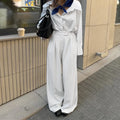White striped wide-leg trousers with front zip fastening and loose casual cut for commuting