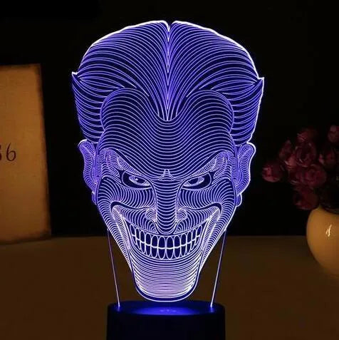 USB-powered 3D acrylic LED lamp showing seven colour options and remote control on a desk.