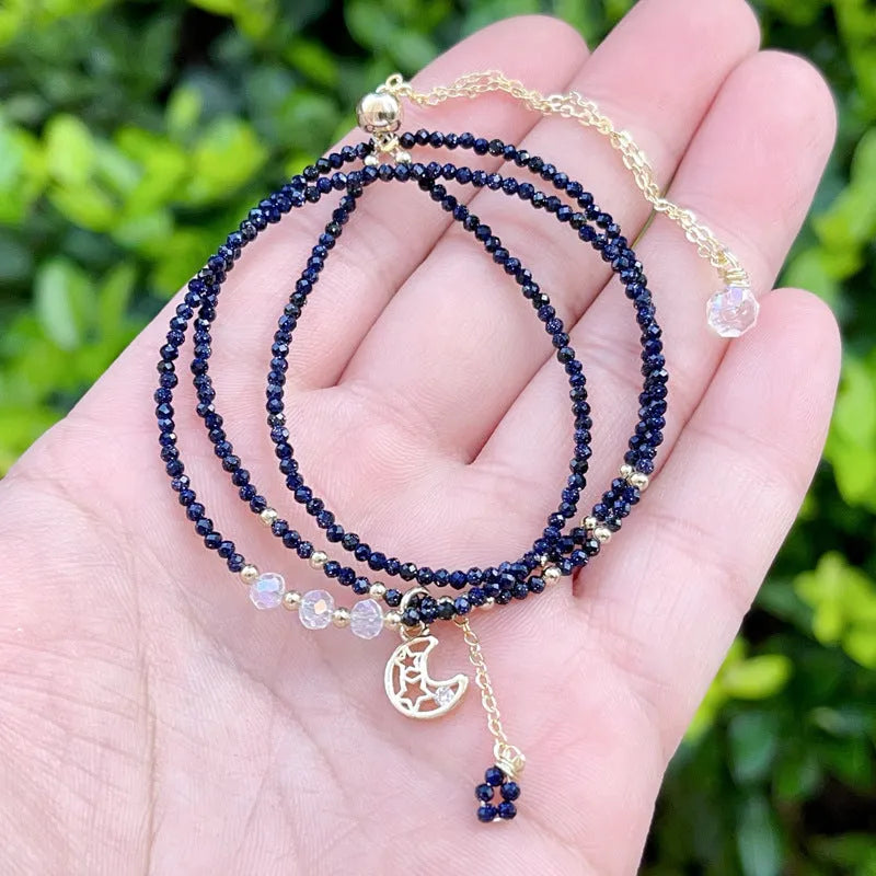 Blue and gold three-ring women's bracelet with sand stone cut beads showing manual processing texture details