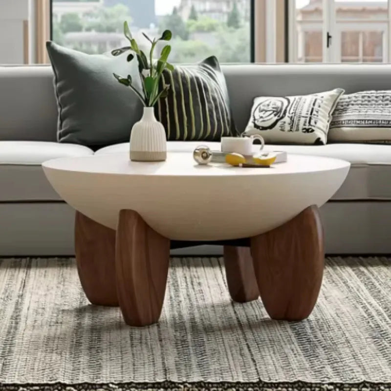 White adjustable height solid wood coffee table shown in a living room setting.
