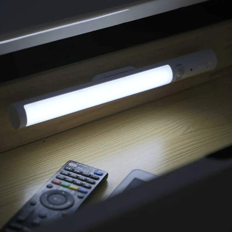 Battery-powered infrared sensor LED wall light with magnetic mount for cabinets.