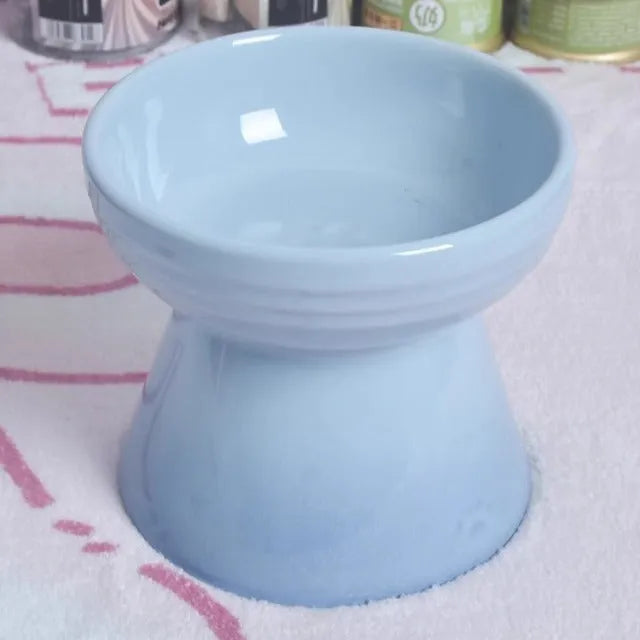 Ceramic anti-tumble pet bowl for dogs and cats with high foot and neck protector.
