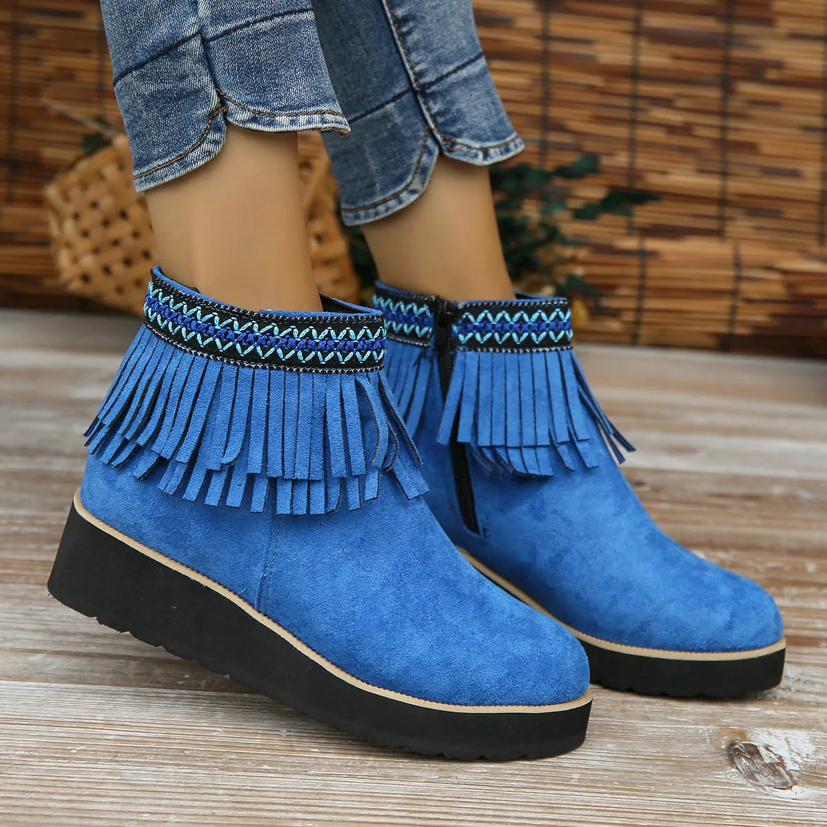 Women's suede wedge ankle boots in dark brown with a side zipper and tassel detail.