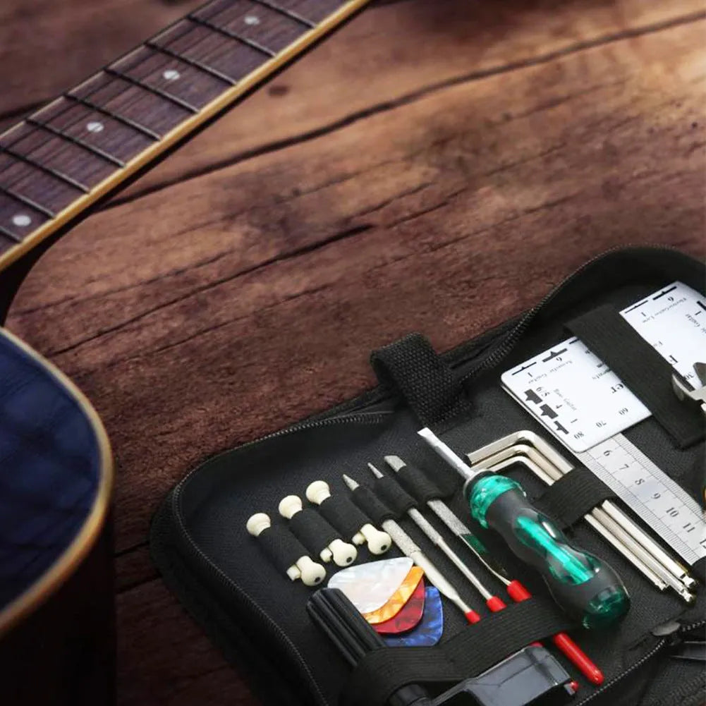 Black plastic guitar repair tool kit case open showing metal maintenance tools for guitar bass mandolin banjo