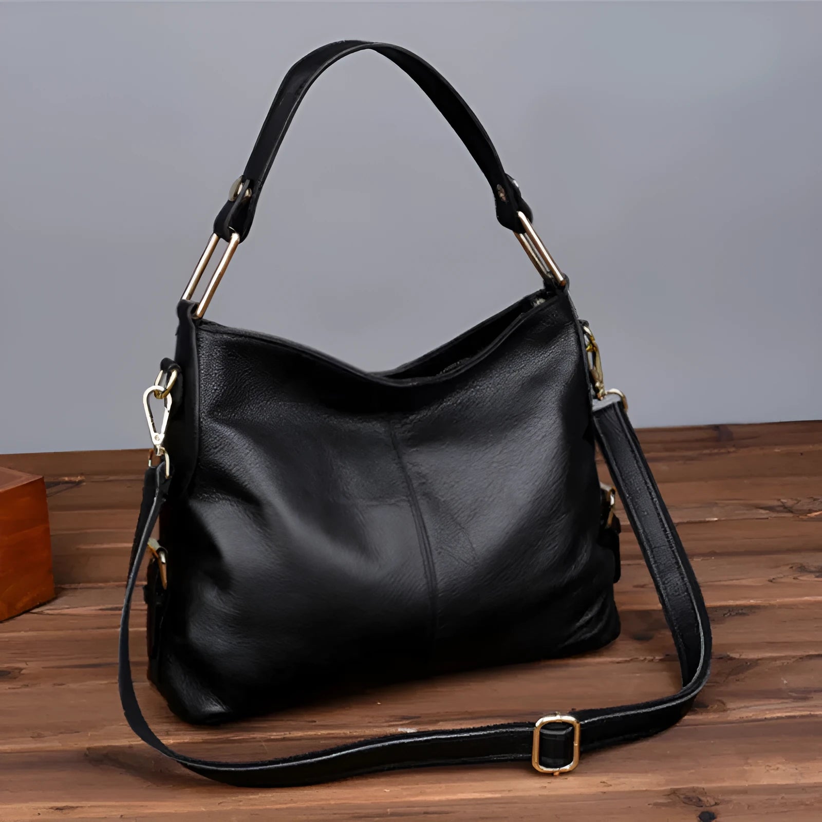Genuine leather vertical square crossbody bag showing multiple internal pockets including a zipper changing bag and mobile phone pocket.