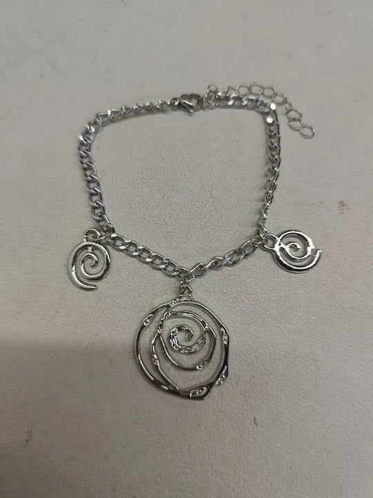 Gold and silver spiral donut pendant necklace, bracelet, and earrings set for women.