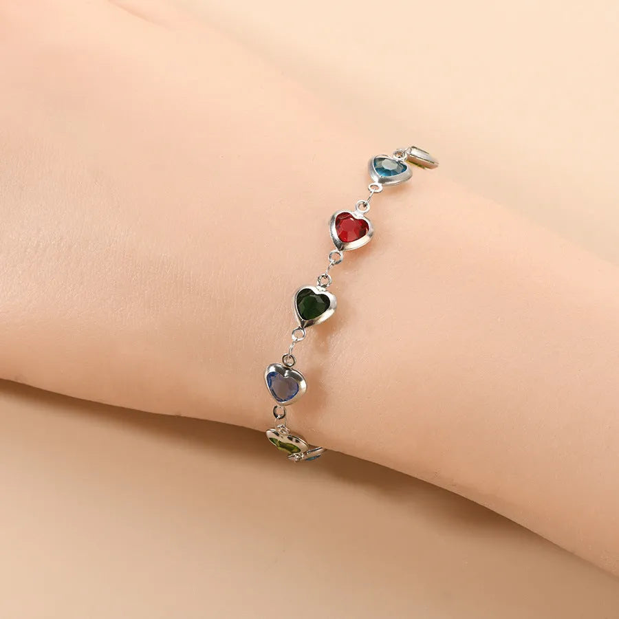 Devil's Eye Creative stainless steel heart bracelet in one of six electroplated colours on a wrist.