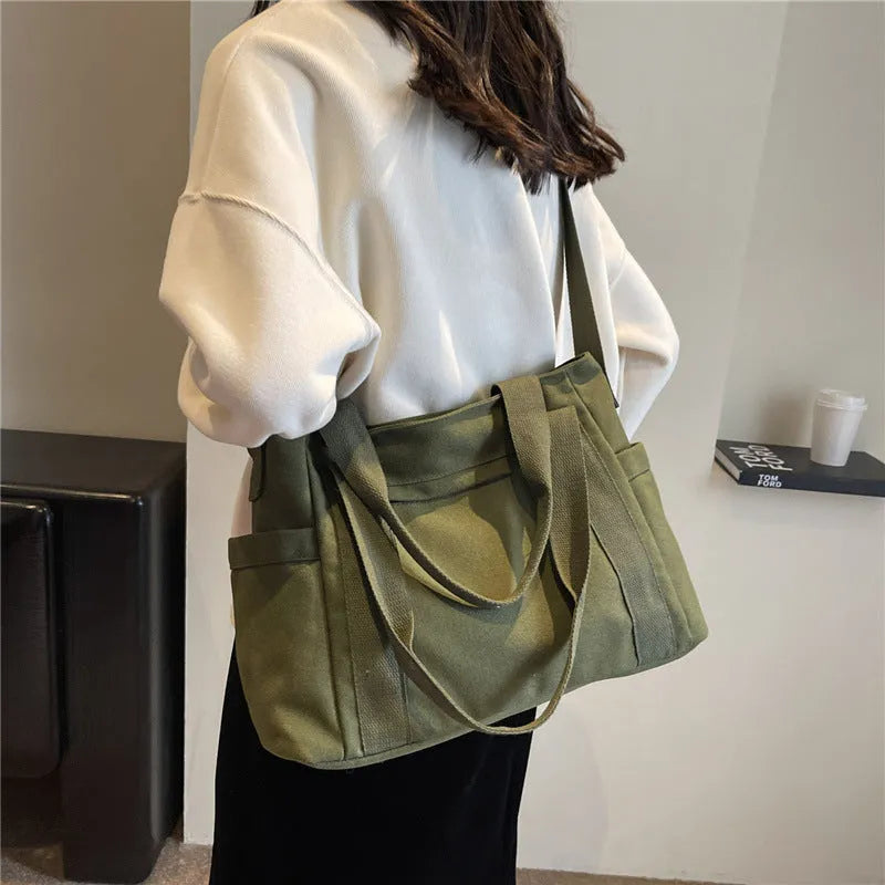 Polyester canvas shoulder bag in solid colour with internal mobile phone pocket organisation