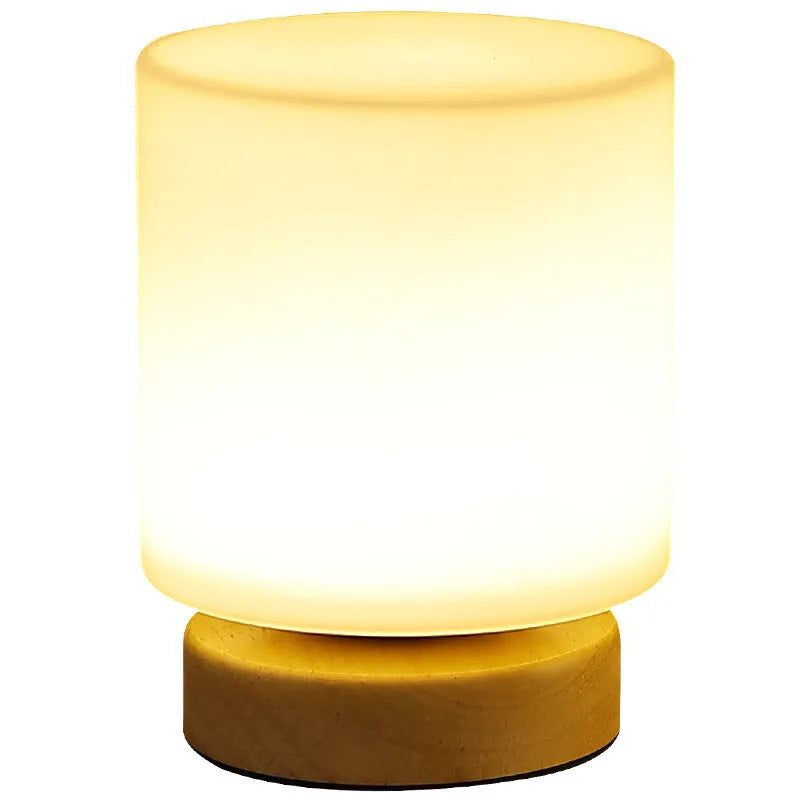 Nordic solid wood USB bedside lamp with flower-shaped design in white cylinder style on wooden surface