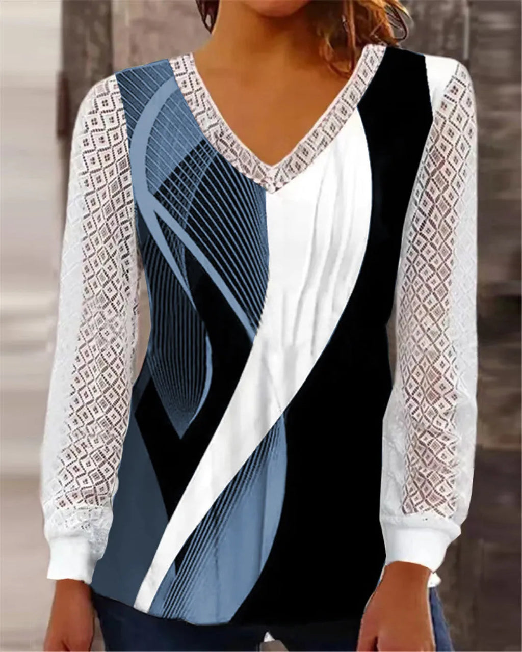 Women's loose purple V-neck pullover top with lace print and long sleeves on a hanger.