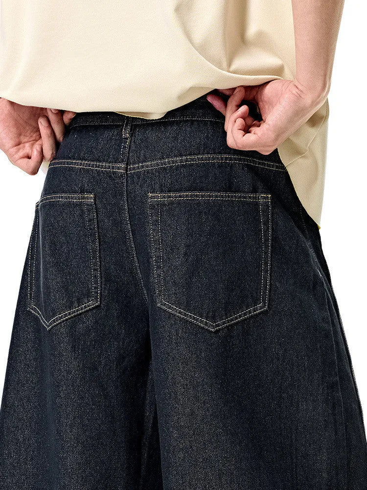 Men's wide leg denim trousers in original cow colour, showing mid waist and relaxed fit.