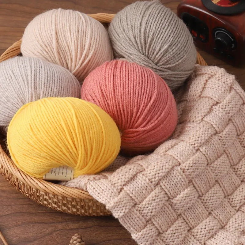 Roll of wool knitting thread for hand-knitted scarves and sweaters in various colour options