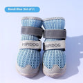 Pair of light blue cartoon-style dog shoes on a white background.